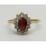 A 9ct gold, garnet and white stone cluster ring, 1.9g, R/S