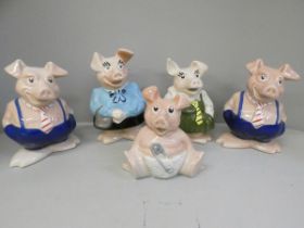 Five Wade Nat West piggy banks, one missing a stopper