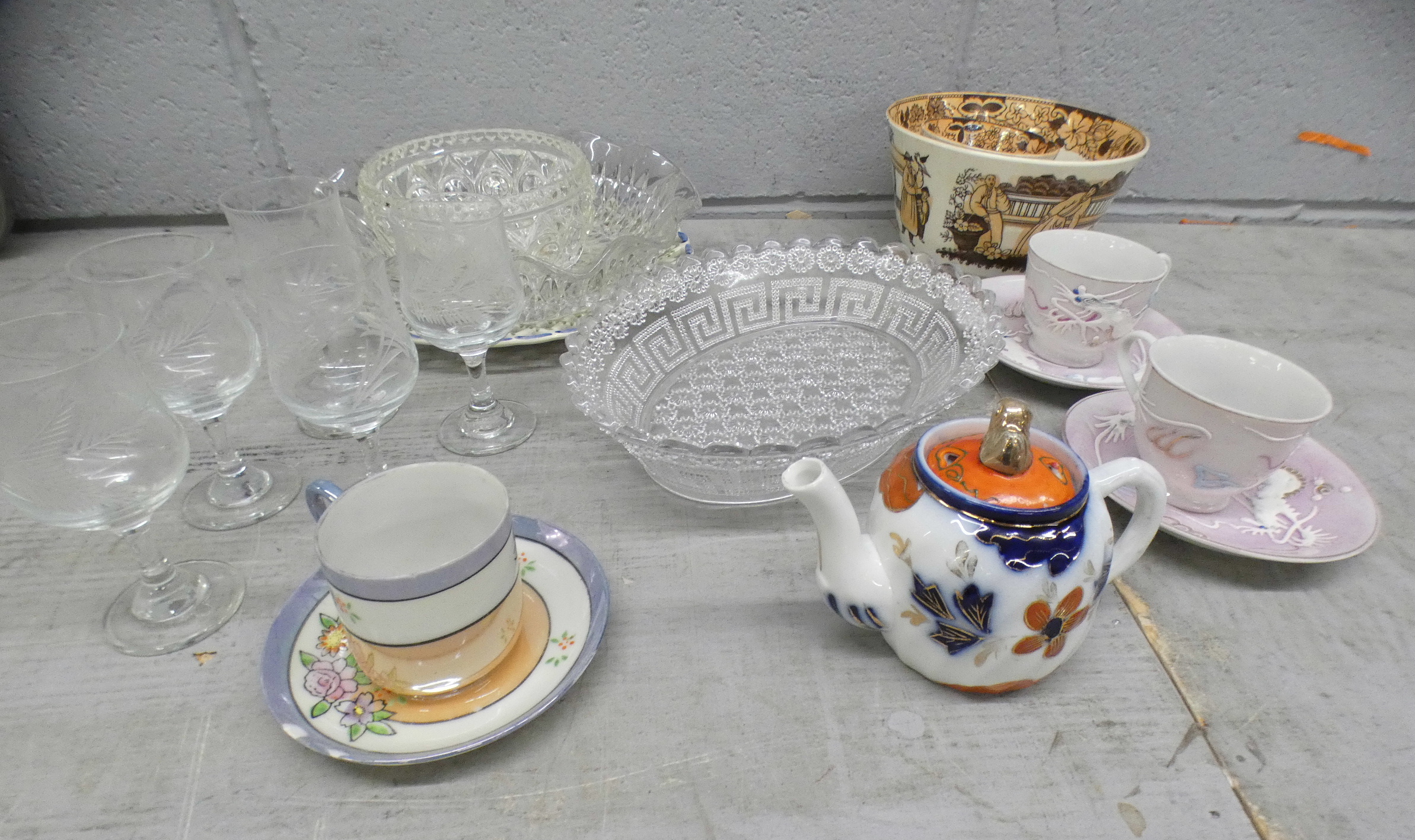 A pair of Geisha Girl cups and saucers, teapot, one other saucer, a Portugese pierced edge plate,