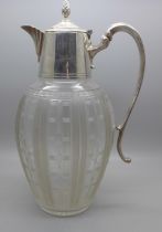 A claret jug with silver plated top