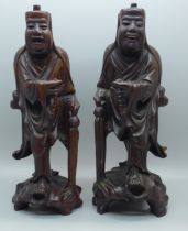 A pair of Chinese hand carved figures of elders, both with small losses, one with bone teeth, 20.5cm