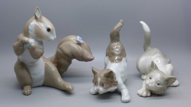 A Lladro squirrel, two Lladro cats and a Royal Crown Derby 2451 coffee can and saucer, star crack on