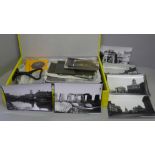 A box of mixed black and white negatives and photographs