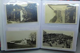 Postcards; a postcard album containing 120 black and white photographic cards