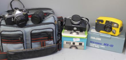 Three cameras; Pentax ME Super with winder, extension tubes and a bag, a Halina 3000 camera and a
