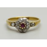 An 18ct gold, ruby and diamond cluster ring with diamond shoulders, 3g, O
