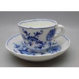 A Meissen small blue and white Blue Onion pattern cup and saucer with crossed swords mark to base