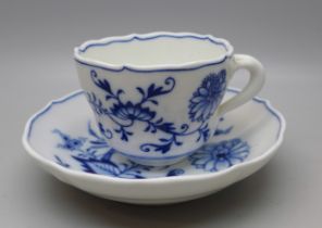 A Meissen small blue and white Blue Onion pattern cup and saucer with crossed swords mark to base