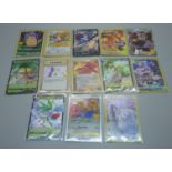 Thirteen Pokemon cards including V-Max, Celebration Holos, etc.