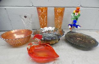 A pair of orange carnival glass vases, two bowls and tray, a Murano glass clown and bird shaped bowl