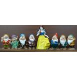 A set of Disney Japan Snow White and the Seven Dwarfs figures, (Snow White, Sneezy, Happy and Doc
