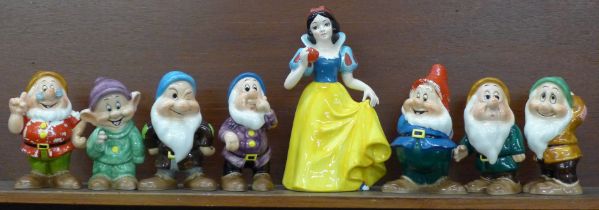 A set of Disney Japan Snow White and the Seven Dwarfs figures, (Snow White, Sneezy, Happy and Doc