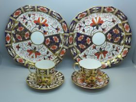 A pair of Royal Crown Derby 2451 pattern plates, cup and saucer and an Imari coffee can and