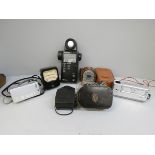 Light meters including Bakelite Weston, Flanimex Sekonic, and a Minolta-16 camera