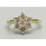 An 18ct gold, seven stone brilliant cut diamond cluster ring, 0.96ct total diamond weight, 3.7g, M