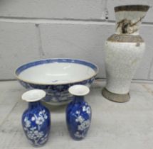 A Chinese blue and white bowl, a/f, a pair of small blue and white vases, chips to rims and one