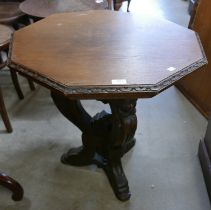A 19th Century Italian Baroque style carved oak octagonal lamp table