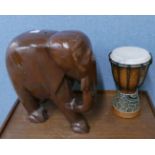 An African drum and a wooden Indian carved wood elephant