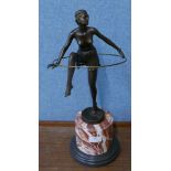 An Art Deco style bronze figure of a dancing hoop girl, on rouge marble socle