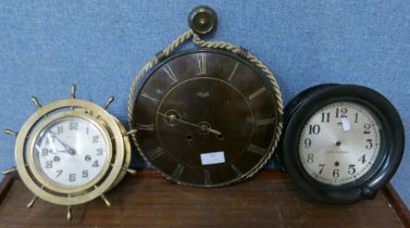 A Waterbury brass ship's wheel wall clock and two others