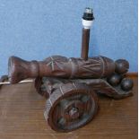 A carved cannon shaped table lamp