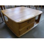 An Ercol Blonde elm Pandora's box coffee table