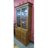 A Victorian Aesthetic Movement carved oak four door bookcase