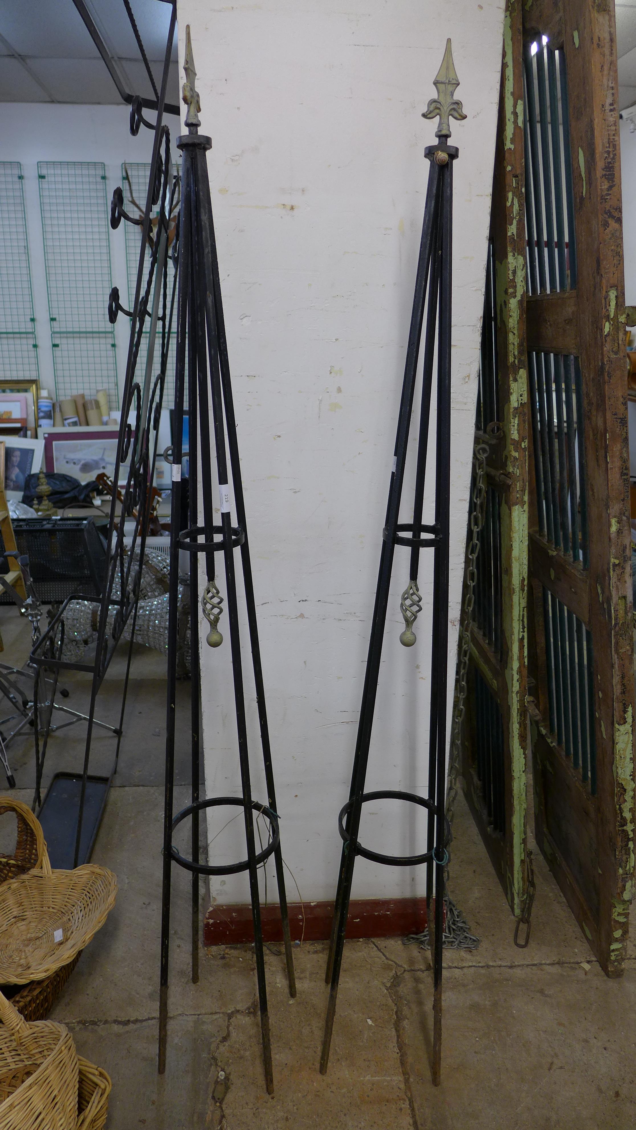 A pair of wrought iron garden plant climbing frames