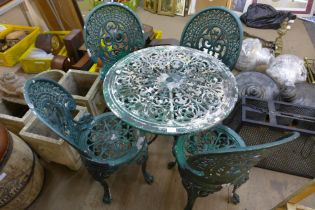 A painted wrought alloy garden table and four chair