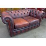 An oxblood red leather Chesterfield settee