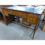 An Edward VII inlaid mahogany and green leather topped three drawer writing table