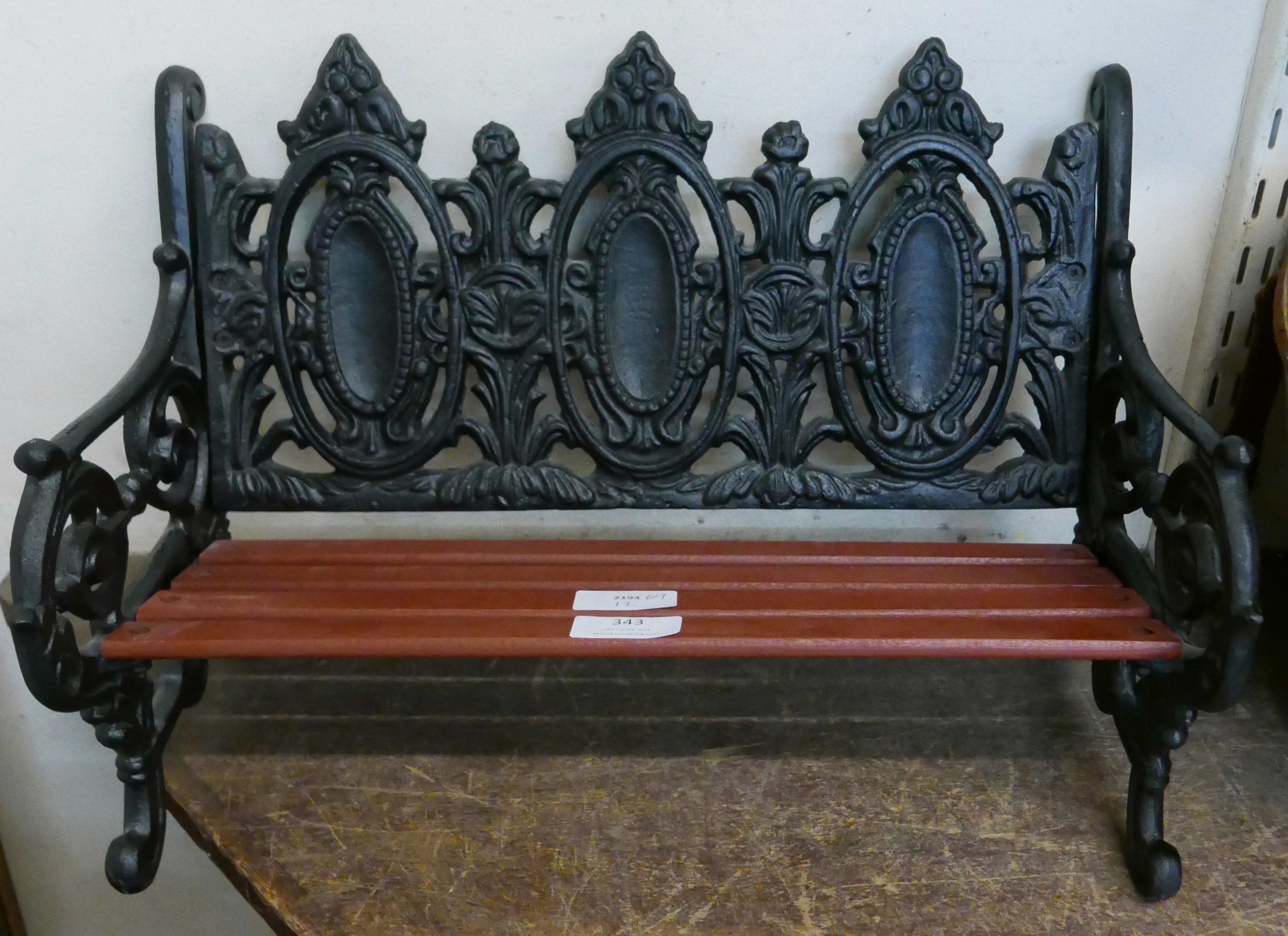 A miniature cast iron and wooden garden bench