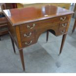 A George III inlaid mahogany five drawer writing table