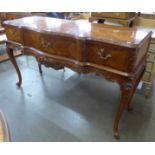 A French kingwood three drawer serpentine serving table