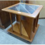 A teak and glass topped coffee table/record cabinet