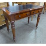 A Victorian mahogany and green leather topped two drawer writing table