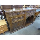 A Victorian Jacobean Revival carved oak green man sideboard