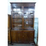 A George III style oak four door bookcase