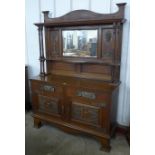 An Arts and Crafts oak mirrorback sideboard