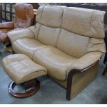 A Norweigan Ekorness beech and leather upholstered reclining settee and ottoman