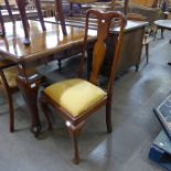 An early 20th Century walnut dining table and six chairs