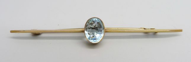 A 9ct gold brooch set with a blue stone, 2.9g