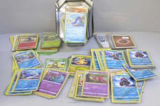 Over 400 holographic Pokemon cards and a tin