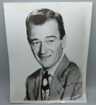 A John Wayne printed autograph picture, 20.5cm wide