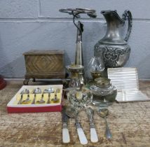 A pewter ewer, plated posy vase, cigarette case and cutlery and a cigarette box, serpentine sun