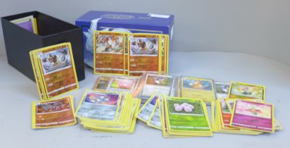 A box of Pokemon cards with more than 150 holographic