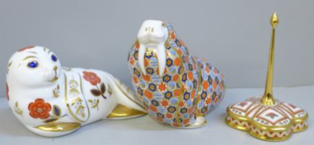 A Royal Crown Derby Walrus paperweight with gold stopper, one other and a Honeysuckle ring stand