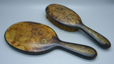 A hand mirror and brush, with carved oriental dragon detail, brush a/f