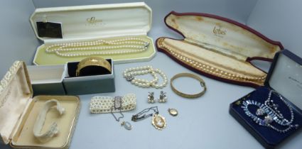 A collection of costume jewellery including strings of pearls, two with silver clasps, a pair of