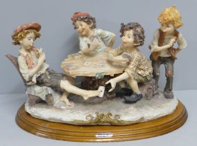 A figure group, The Card Players, made in Greece, 40cm (a/f, finger tip missing)